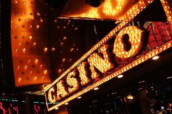 Mobile phone screen showing live betting interface with game information and dealer video feed